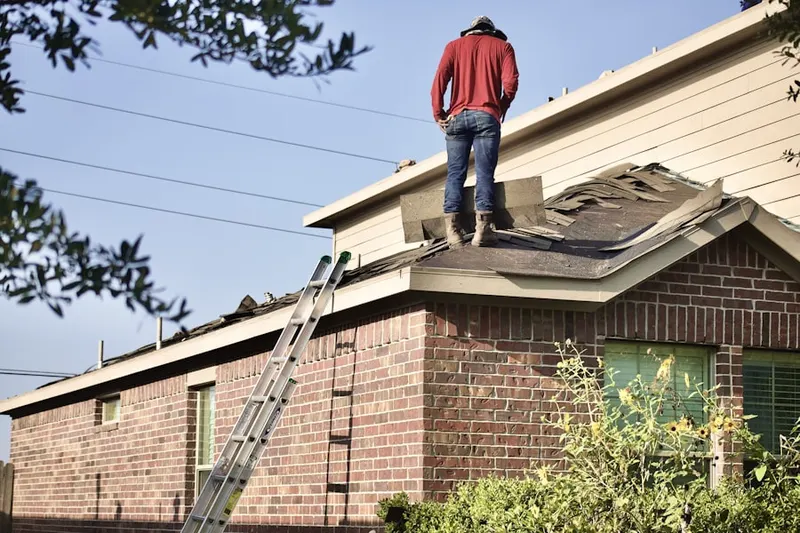 Professional roofer working on a residential roof in Reels Mill